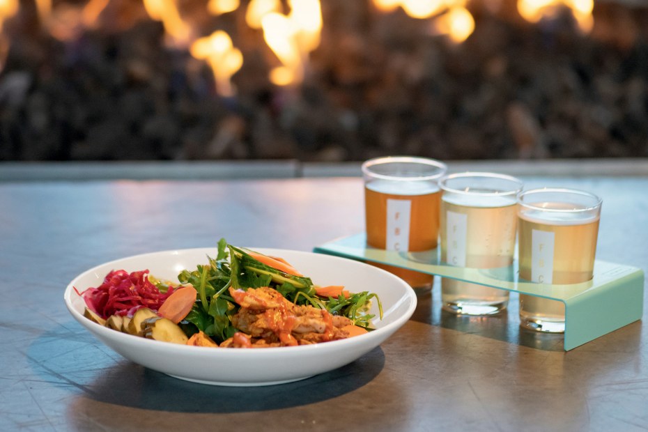 Kombuchas and chicken salad on an outdoor table at the Ferment Brewery.