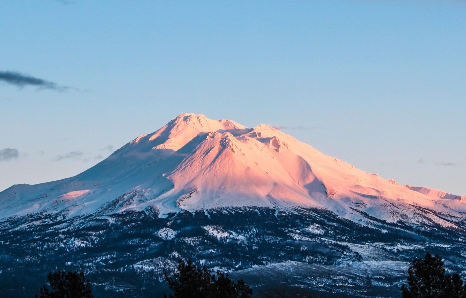 Mount Shasta lit up at sunset.