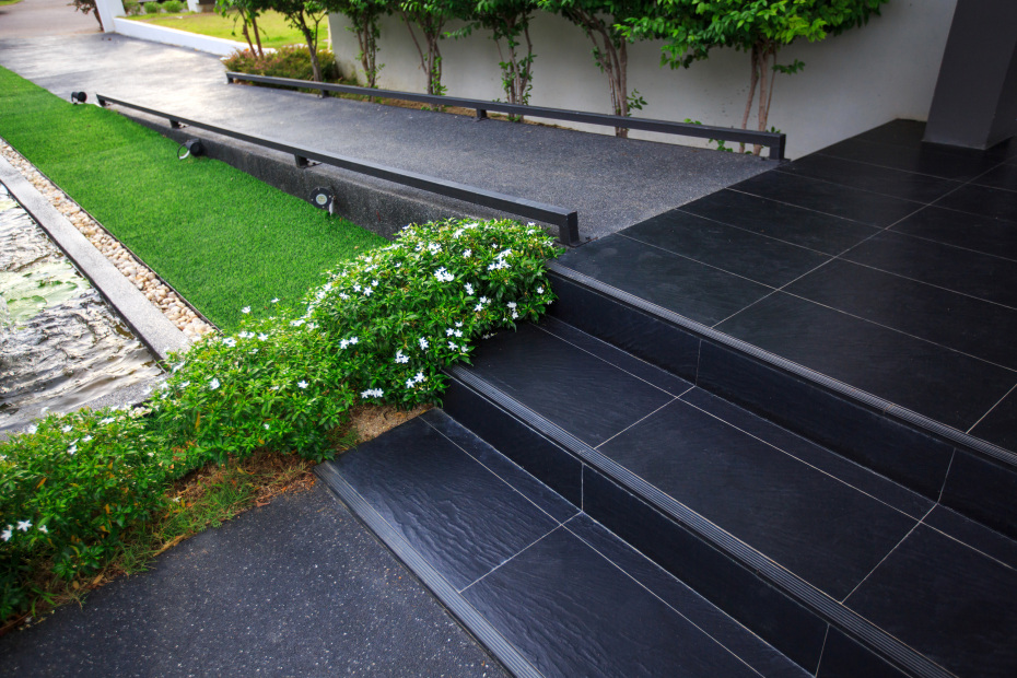 A modern black ramp leads up to a front door.