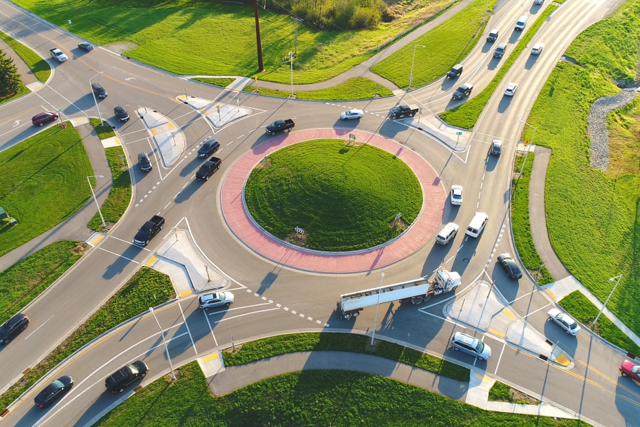 cars and trucks enter a roundabout.