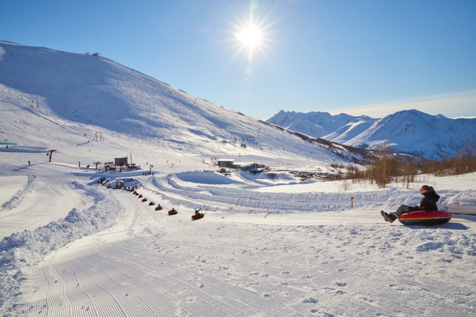 Kids ride the tubing hill at Arctic Valley Ski Area in Anchorage, Alaska.