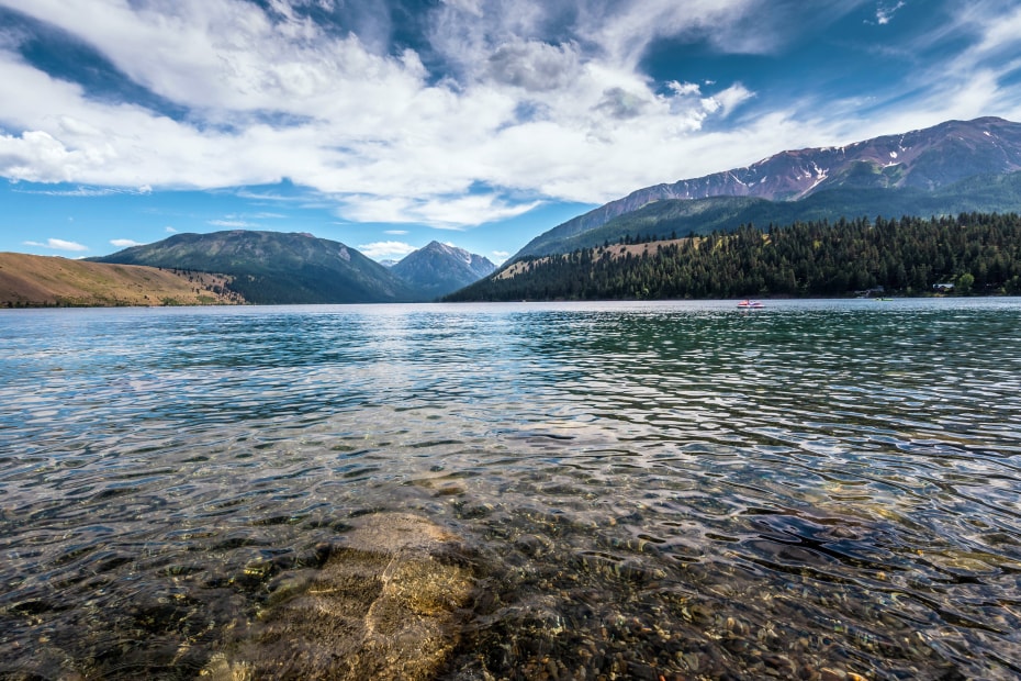 The clear blue water of Wallowa Lake with the Wallowa mountain range in the background.