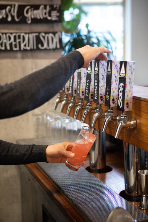 A cocktail is poured at Amalga Distillery.