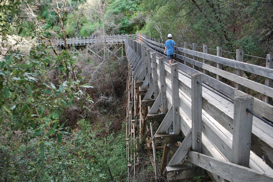 a boy walks along a former flume on the Independence Trail in Nevada City, picture
