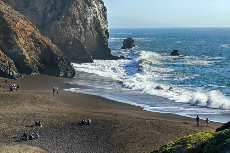 Visitors gather on a wide beach off the Tennessee Valley Trail in the Marin Headlands, picture