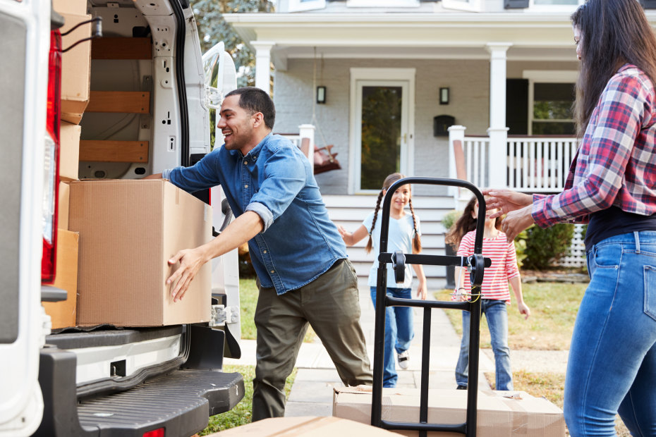 picture of two girls helping their parents load up the truck on moving day