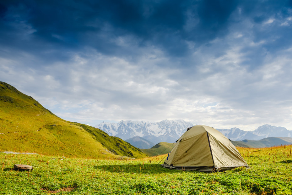 picture of a pitched tent on the grass overlooking beautiful view