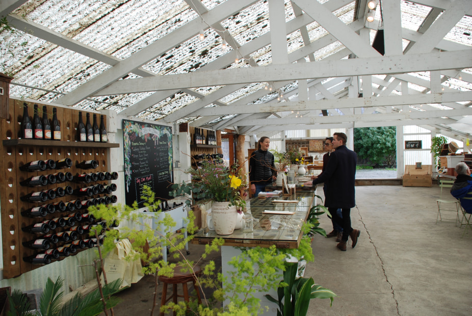 a couple enjoys a wine tasting in Heidrun Meadery's greenhouse 