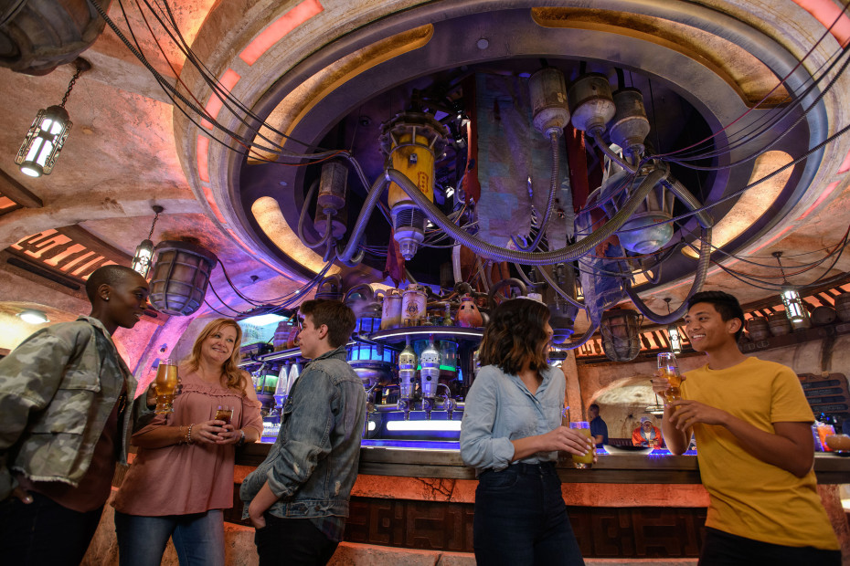Visitors socialize and drink at Oga's Cantina, Disneyland's first bar, in Star Wars: Galaxy's Edge