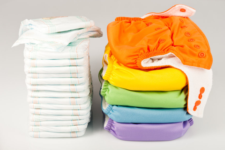 a stack of disposable diapers and reusable diapers lined up next to each other