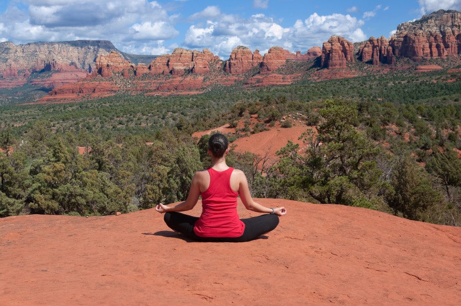 woman meditating with the red rocks of Sedona, Arizona, in the background