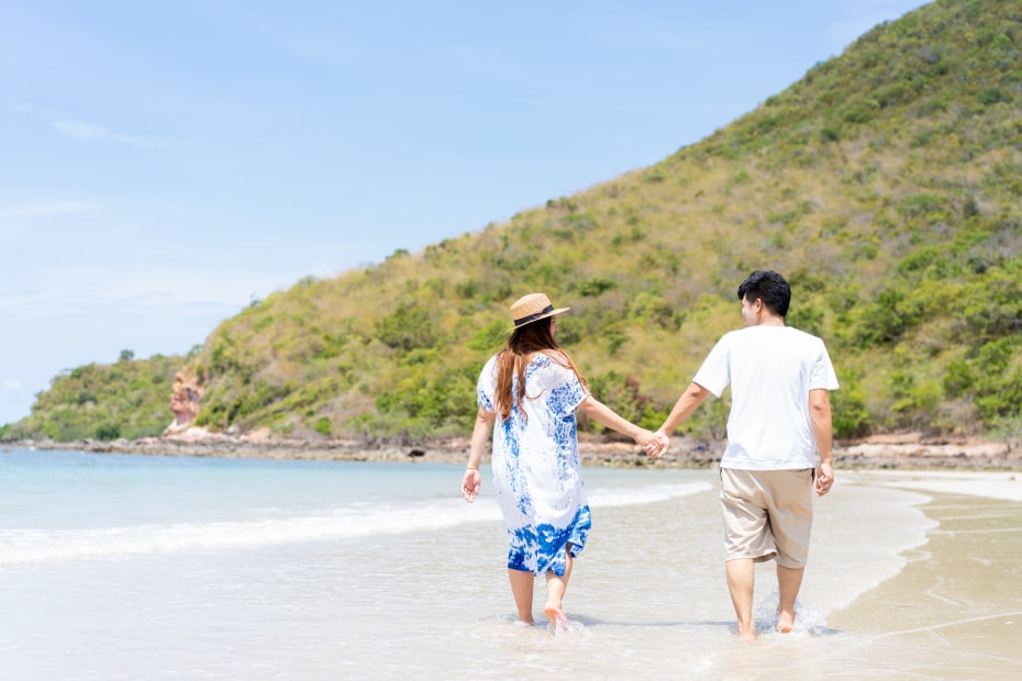 couple walking on beach in tropical location