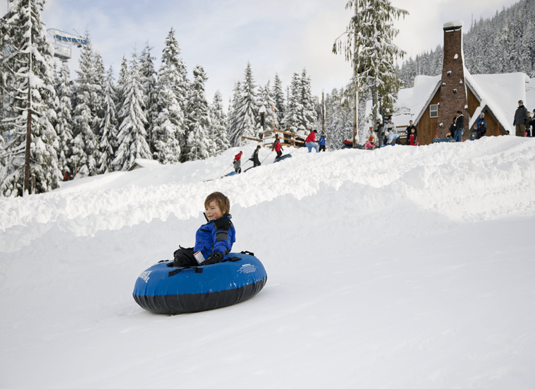 a young boy tubes down a hill at Skibowl in Mount Hood, Oregon, picture