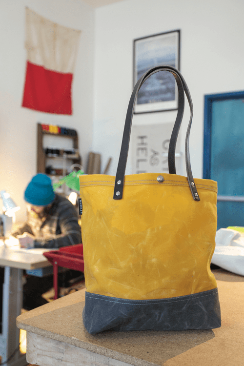 a yellow and gray tote on display in Wheeler Bag Co. in Astoria, Oregon