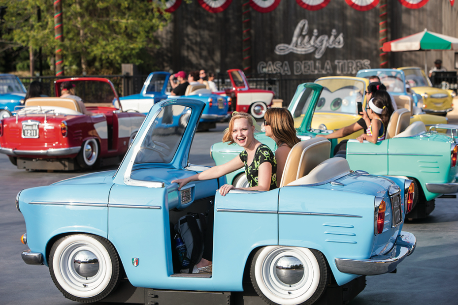 Kids laugh while riding Luigi's Rollickin' Roadsters ride at Disneyland