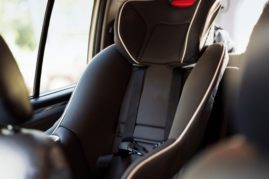 A clean forward facing car seat in the back seat of a car.