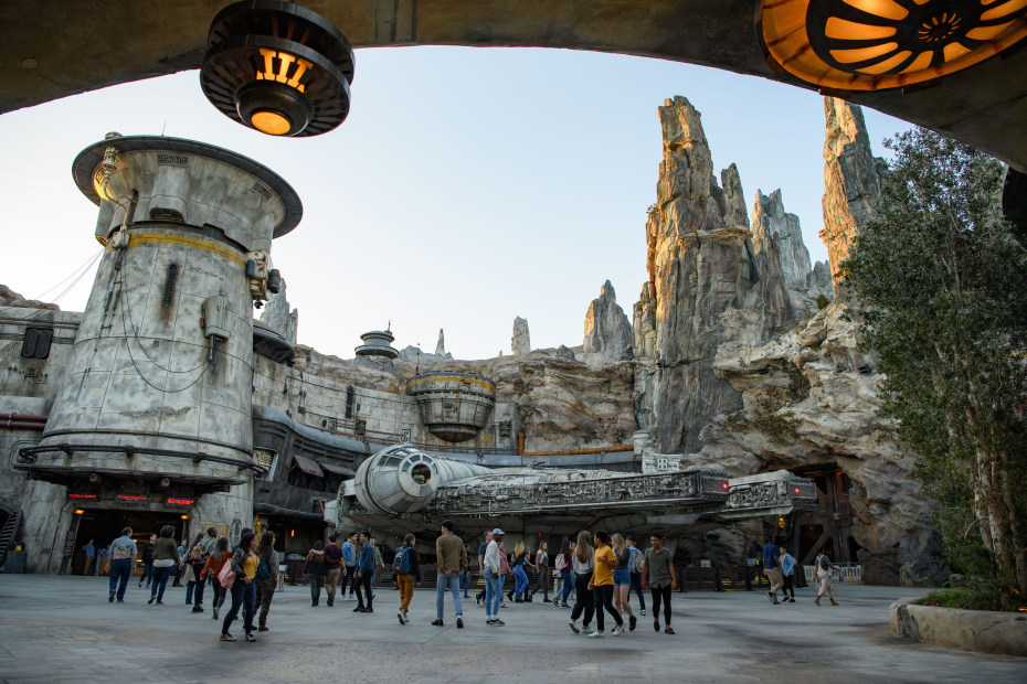 Visitors walk in front of Millennium Falcon: Smugglers Run in Disneyland.