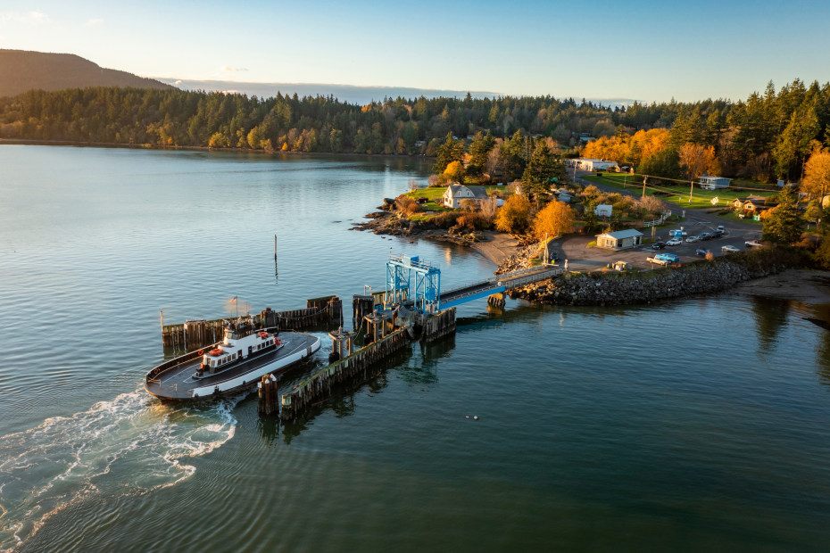 A car ferry arrives at the small dock at Lummi Island, Washington on a clear fall day.