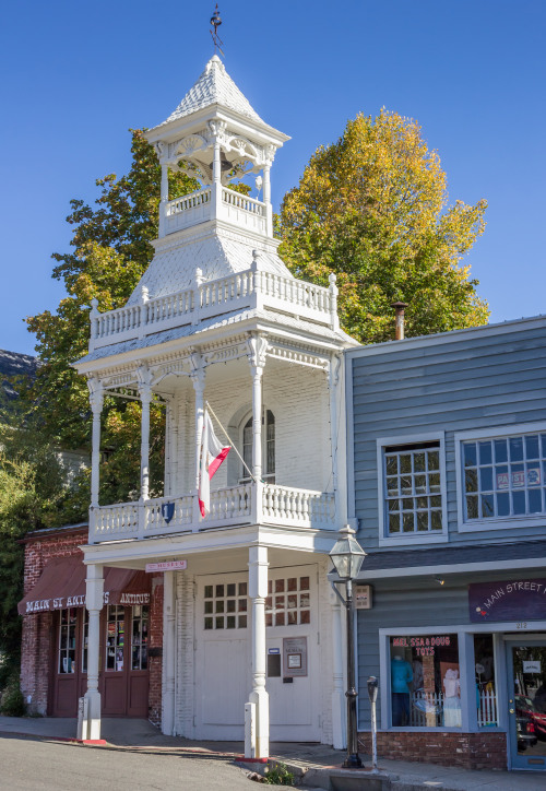 Historical white wooden firehouse in main street Nevada City, California.