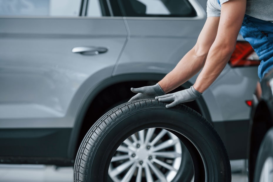 A mechanic inspects a tire.