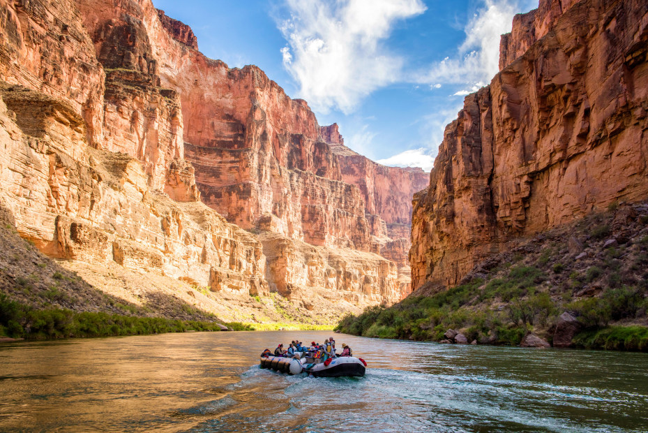 A raft with Grand Canyon Expeditions floats down the Colorado River in the Grand Canyon.