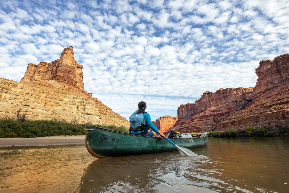 A person canoes on Green River Canyon in Utah's Canyonlands National Park.