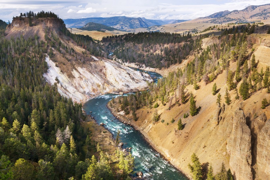Yellowstone River flows through the Grand Canyon of the Yellowstone on a cloudy day.