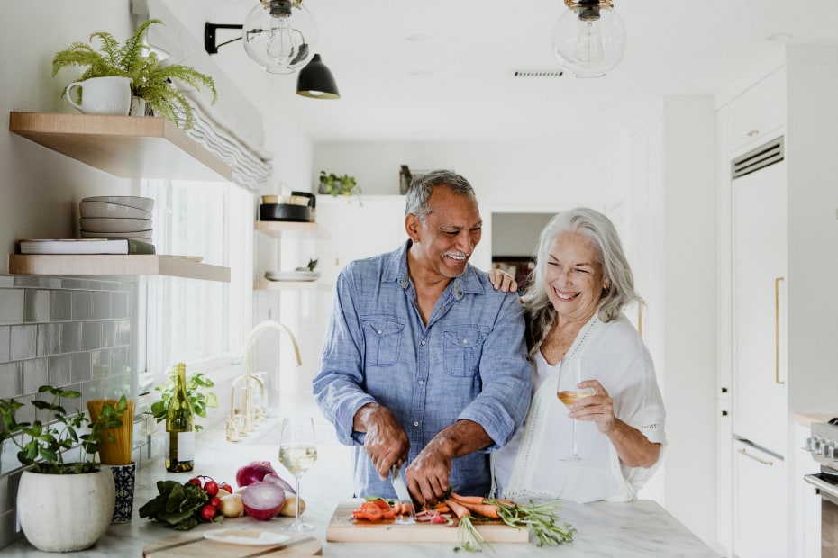 A couple cook together in their newly renovated kitchen.