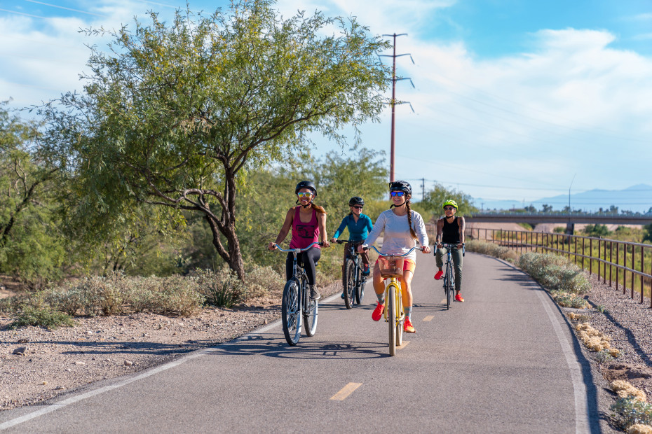 A group of friends ride on a dedicated bike path in Tucson, Arizona.