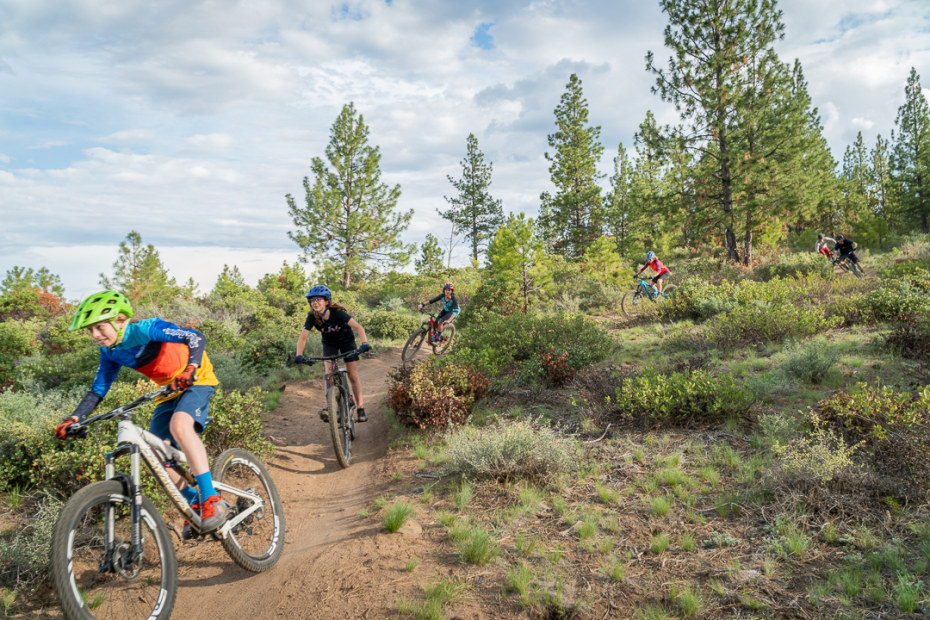 A family mountain bikes on Phil's Trail in Bend, Oregon.