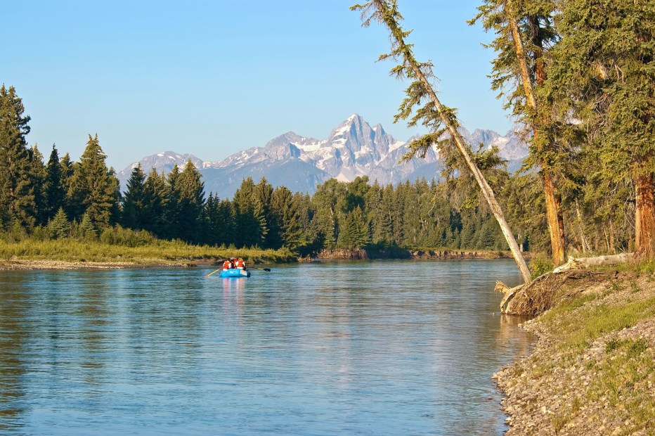 A group floats a raft down the Snake River in the Grand Tetons National Park.