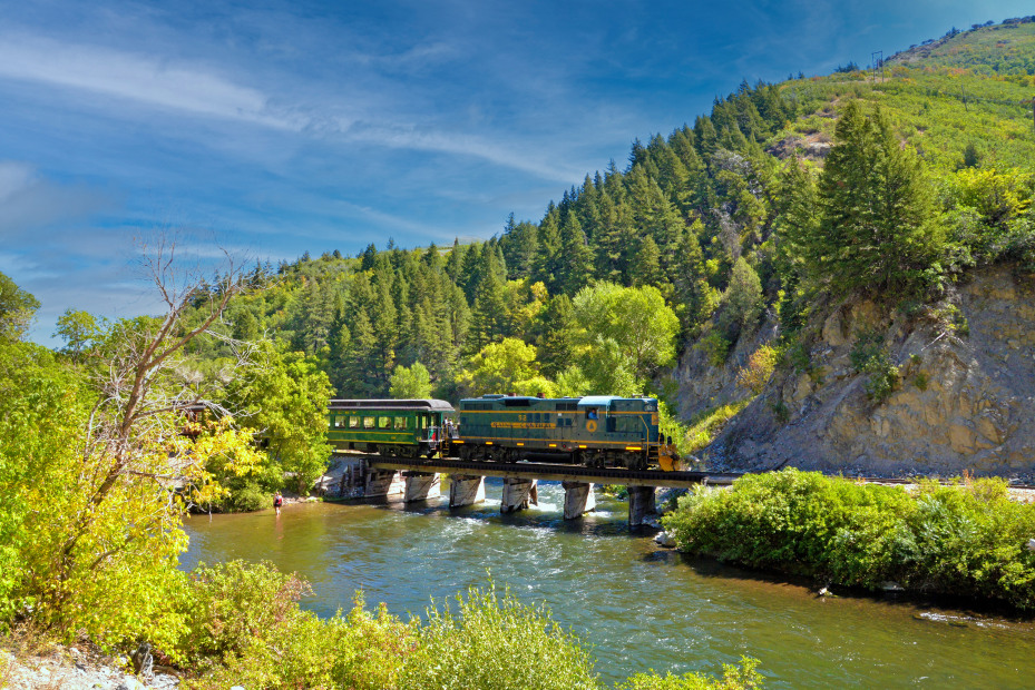 An engine on the Heber Valley Historic Railroad crosses a river bridge in Utah.