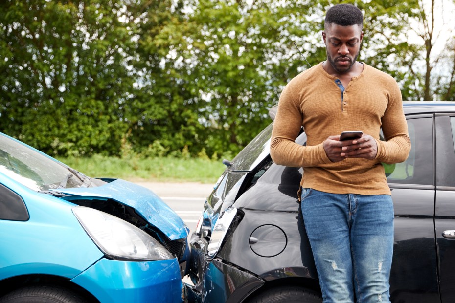 A driver calls for roadside assistance after being rear-ended.