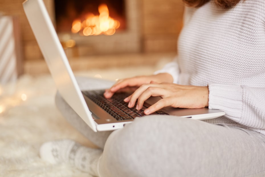 A woman books airline tickets on her laptop.