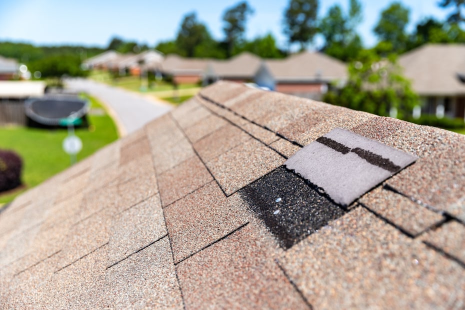 A broken shingle on a home roof.