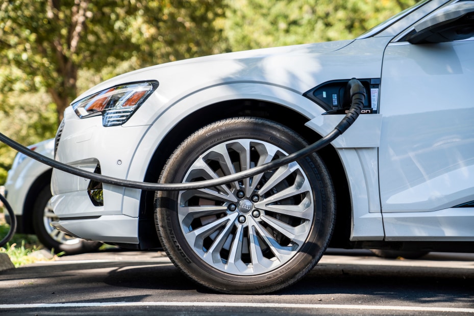 A white EV charging on a road trip.