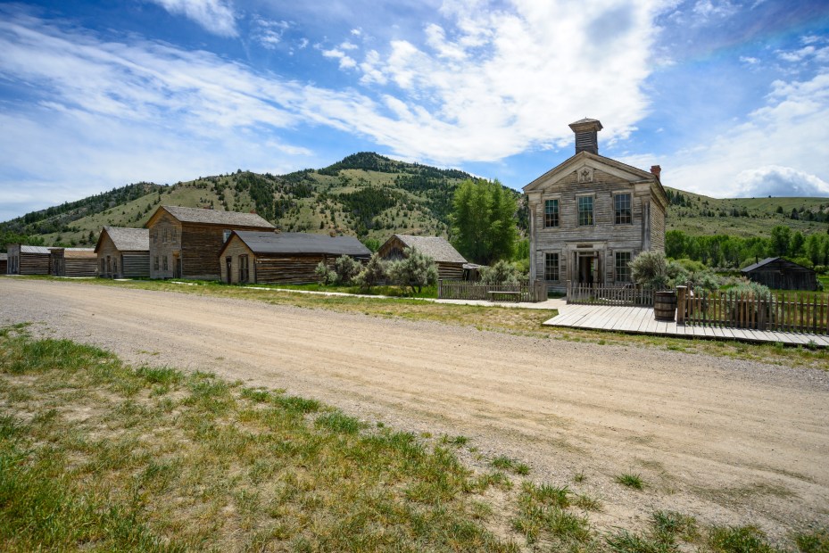 Historic buildings line a dirt road in Bannack State Park in Beaverhead County, Montana.