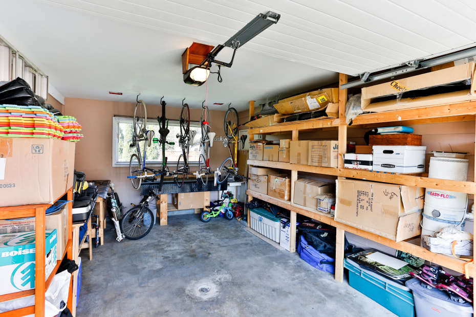 Boxes line shelves inside a bright garage.