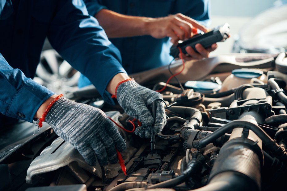 A mechanic tests a car's battery and charging system.