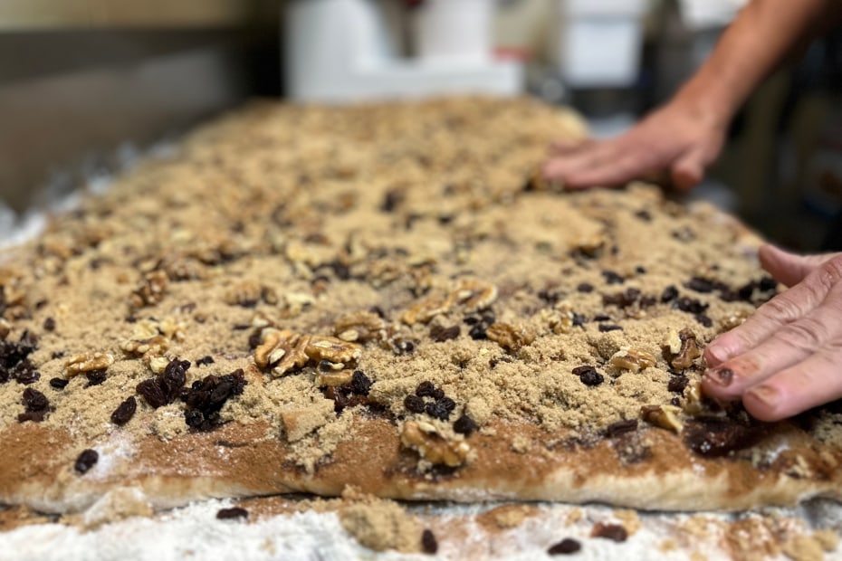 A baker makes a large slab of cinnamon roll dough at Red Rock Cafe in Sedona, Arizona.