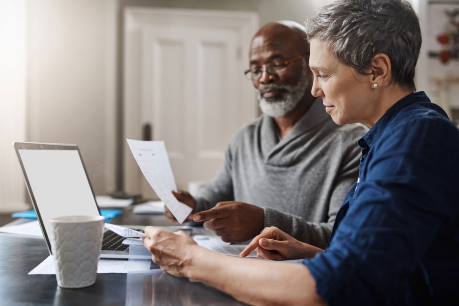 A couple go over the retirement assets together at the kitchen table.