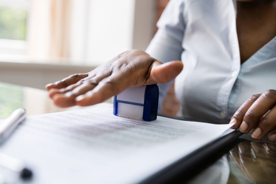 A notary stamps a document.