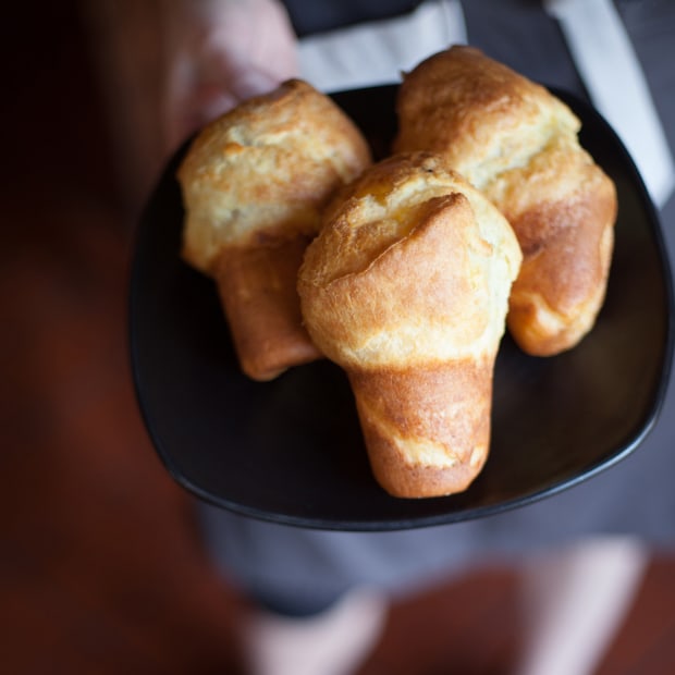 A waiter holds a plate of popovers from Station House Café in Point Reyes Station.