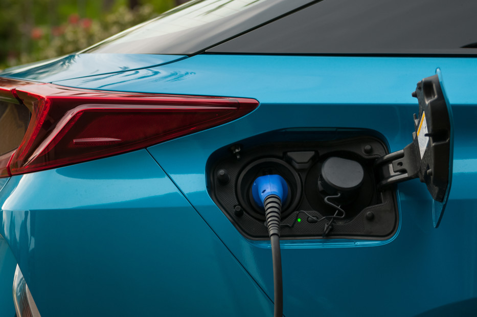 Blue Prius Prime plug-in hybrid charging.