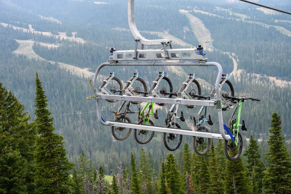Chairlift at Big Sky Resort with a full load of mountain bikes being carried to the top of the mountain.