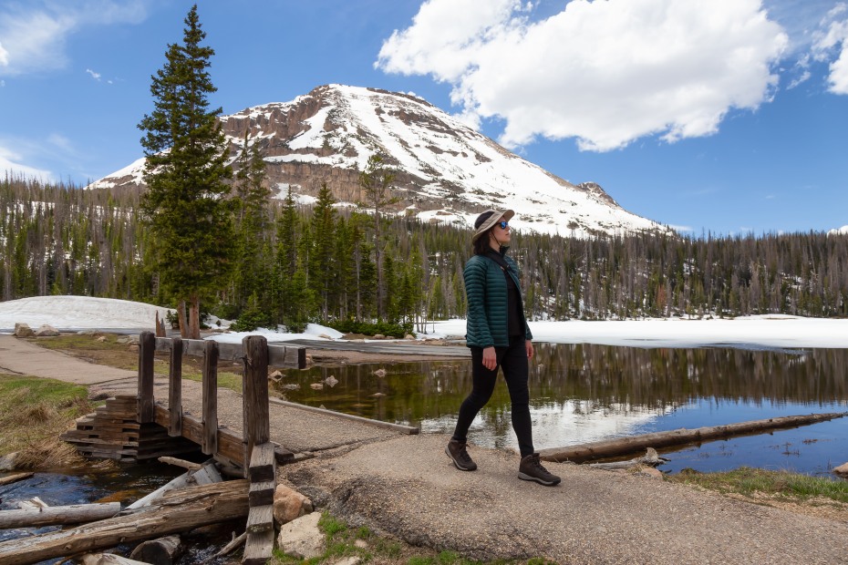 a woman hikes around Utah's Mirror Lake.
