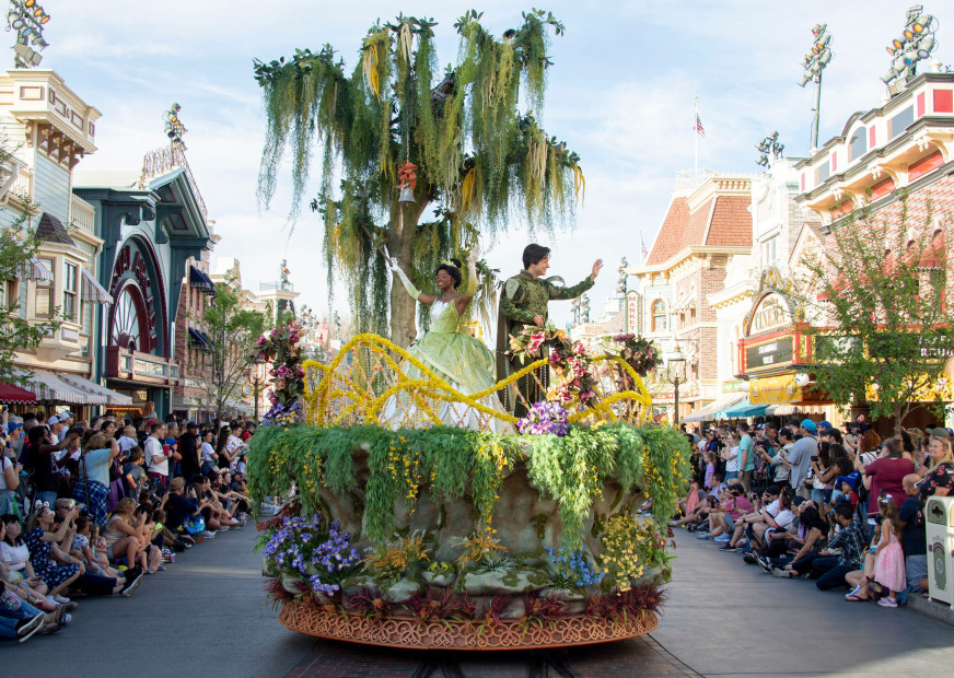 The Princess and the Frog characters wave at onlookers during the Magic Happens Parade at Disneyland.