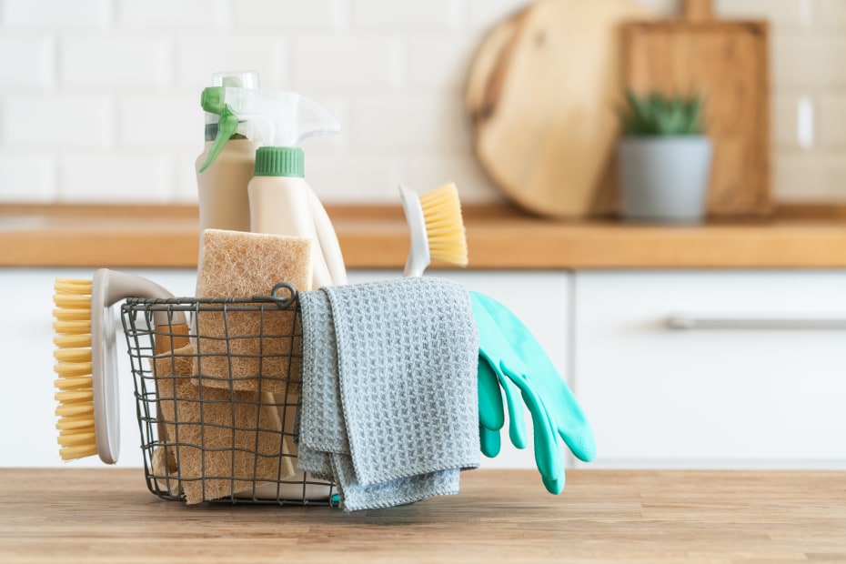 eco-friendly cleaning supplies in a basket on the kitchen counter