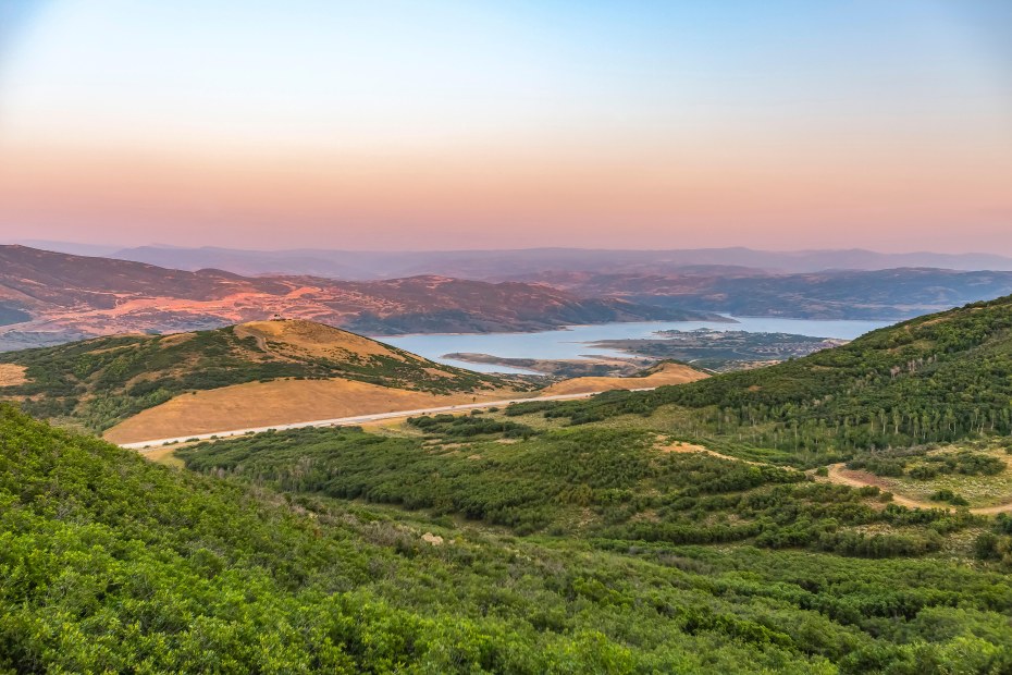 The sunset turns the sky over Jordanelle State Park orange and pink.