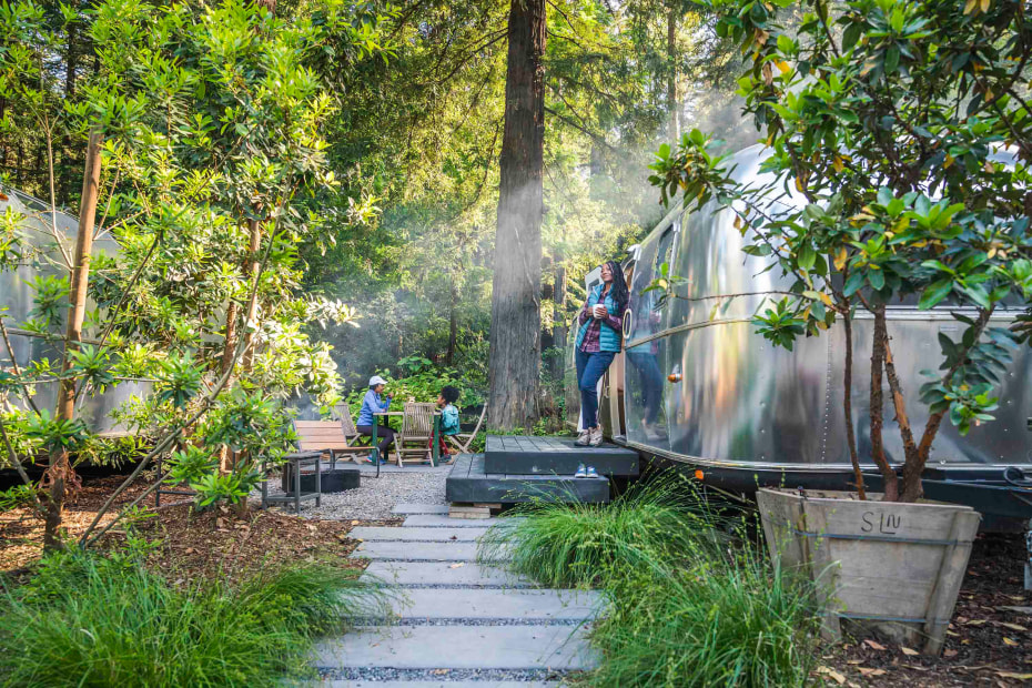 An Airstream sits among the trees at Autocamp.